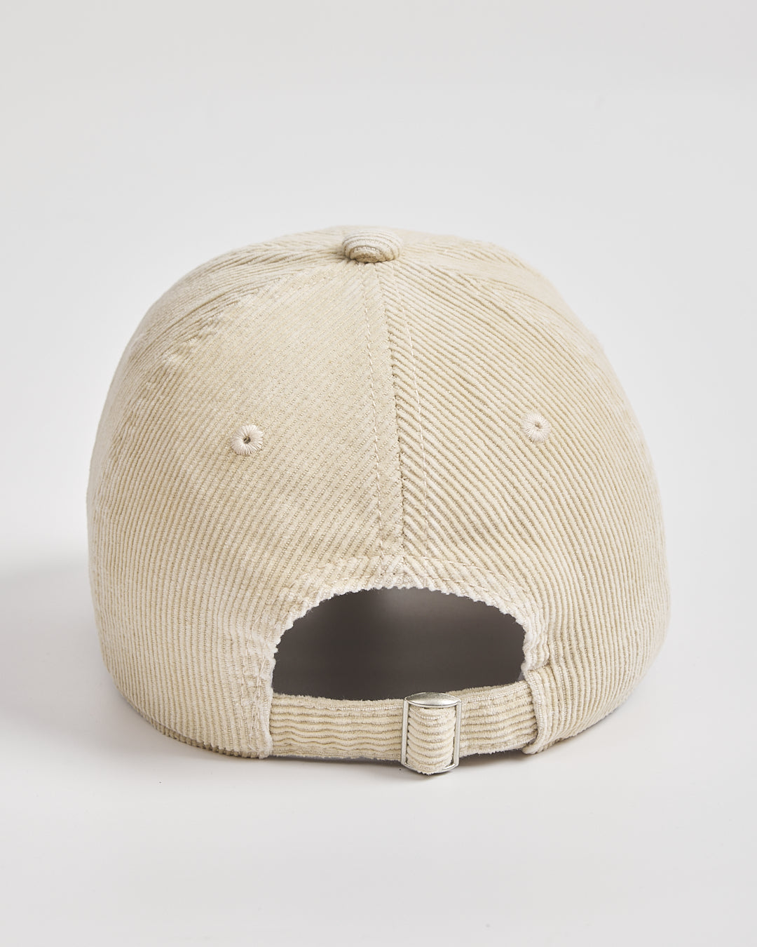 Cream corduroy cap on a light gray background