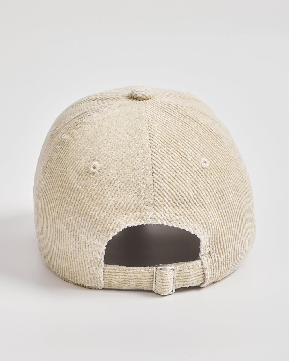Cream corduroy cap on a light gray background