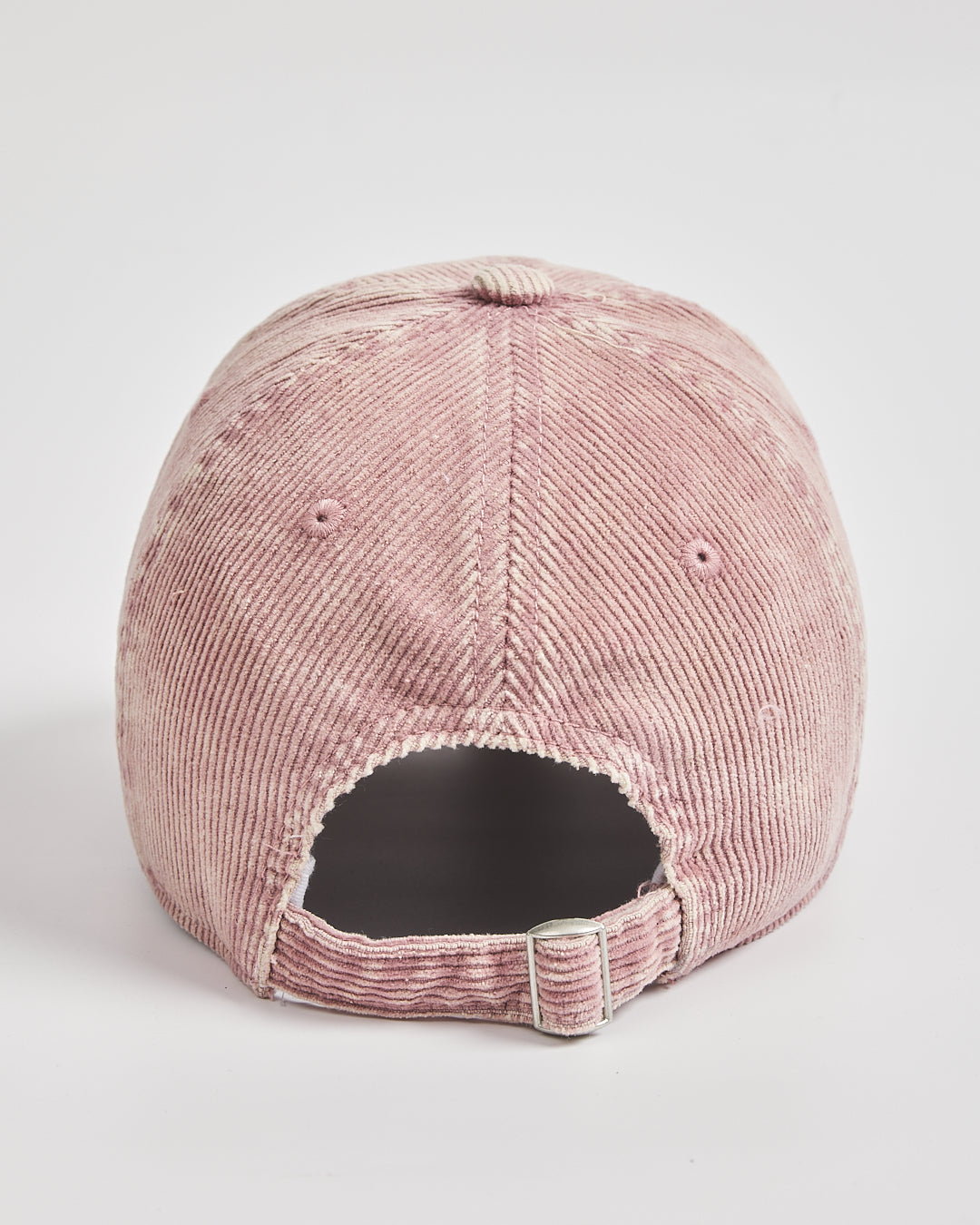 Pink corduroy cap on a light gray background
