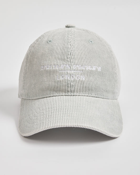 Light gray corduroy cap with white text on a light gray background