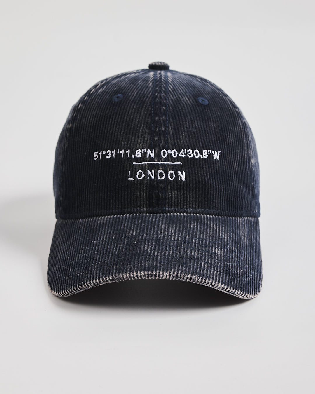 Navy cap with white text on a light gray background