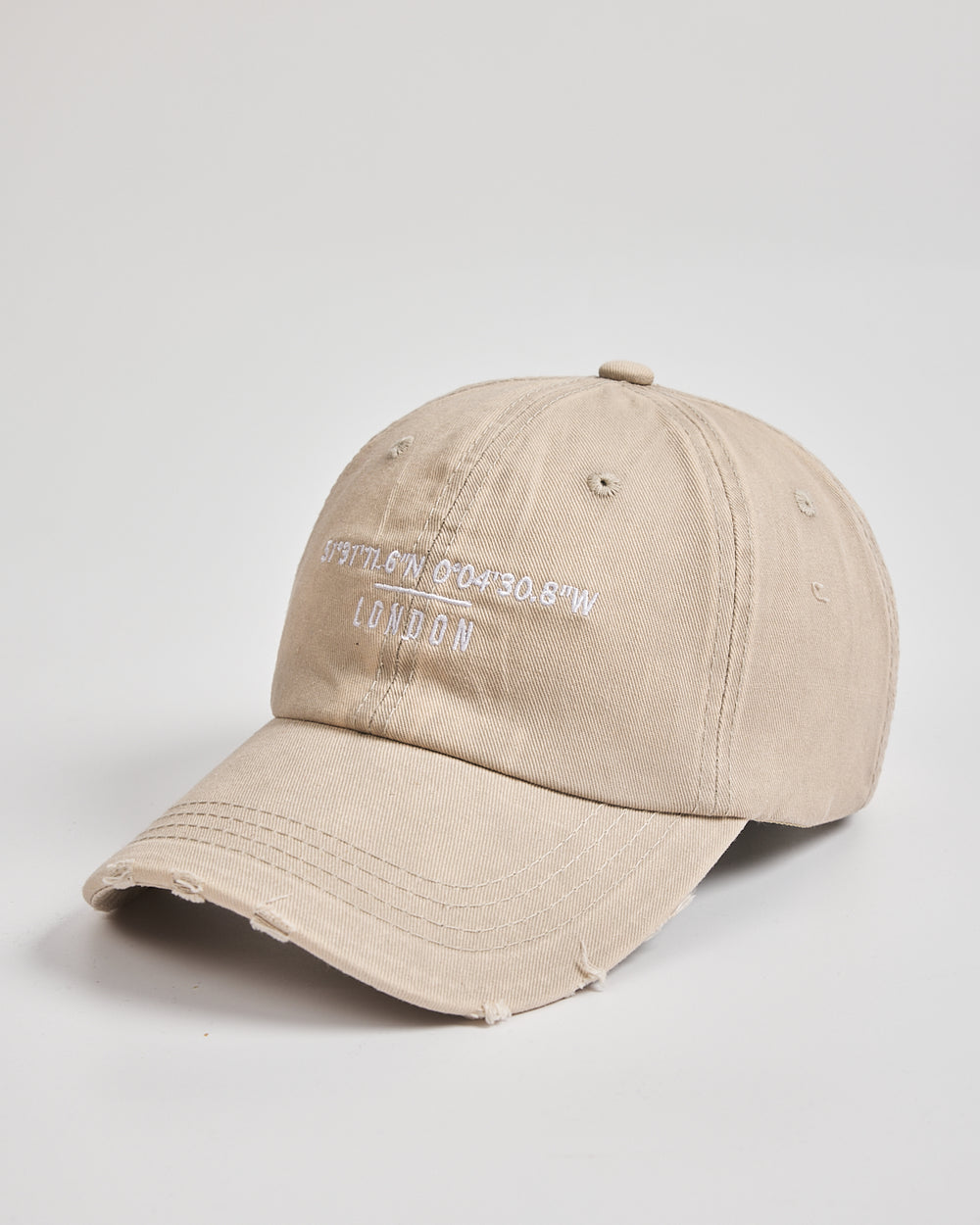 Beige cap with white text on a light gray background