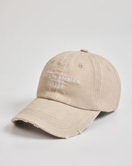 Beige cap with white text on a light gray background