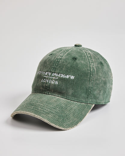 Green corduroy cap with 'London' text on a light gray background