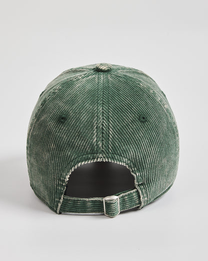Green corduroy cap on a light gray background