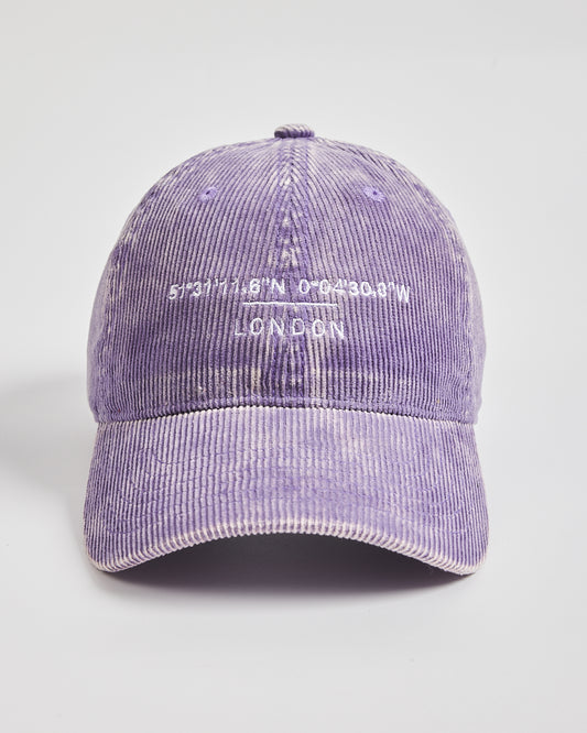 Purple corduroy cap with white text on a light gray background