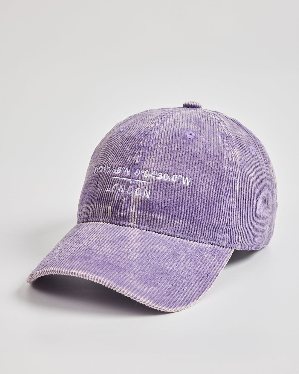Purple corduroy cap with text on a light gray background