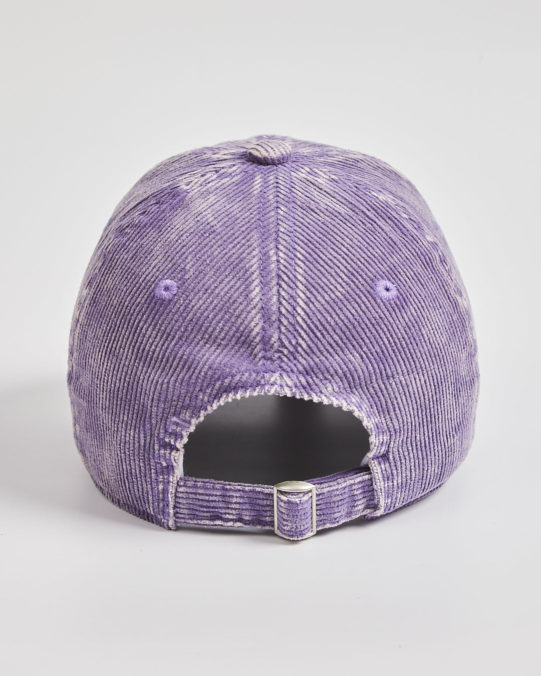 Purple distressed baseball cap on a light gray background