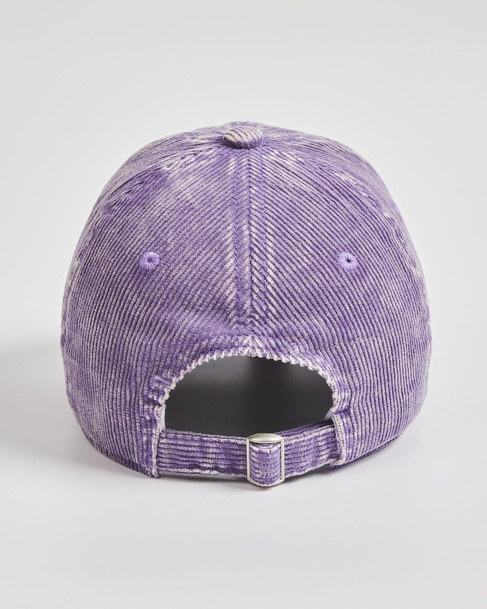 Purple distressed baseball cap on a light gray background