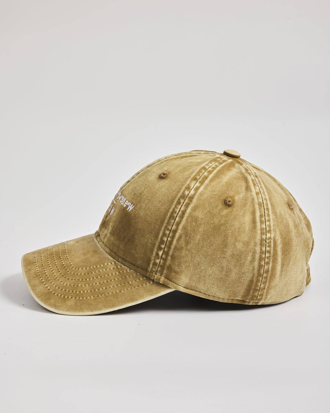 Yellow baseball cap on a light gray background