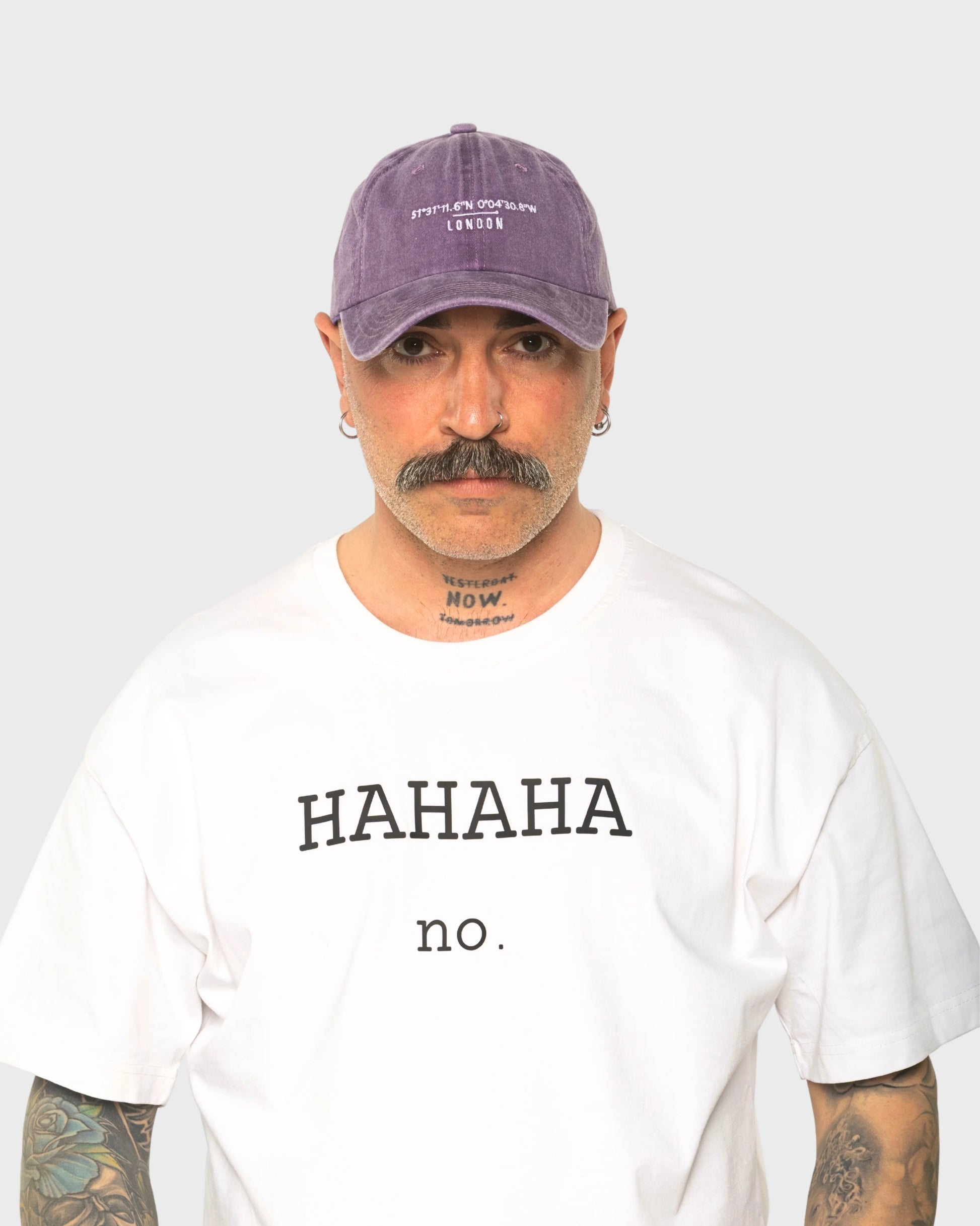 A man wearing the London Purple Washed Cap