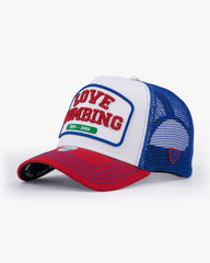 Trucker hat with 'Love Bombing' text on a white background