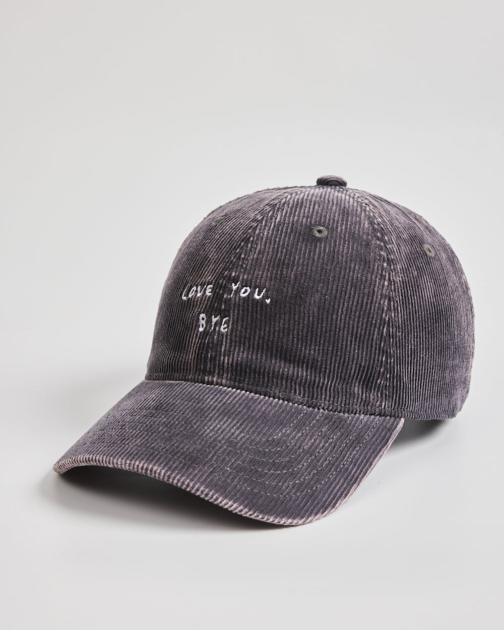 Gray corduroy cap with 'LOVE YOU, BYE' text on a light gray background
