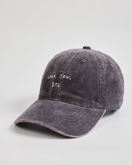 Gray corduroy cap with 'LOVE YOU, BYE' text on a light gray background
