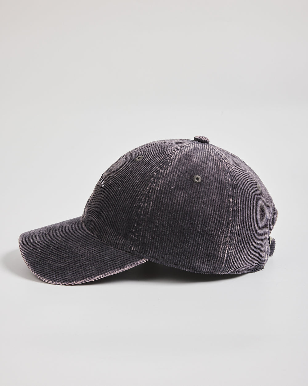Dark gray corduroy cap on a light gray background