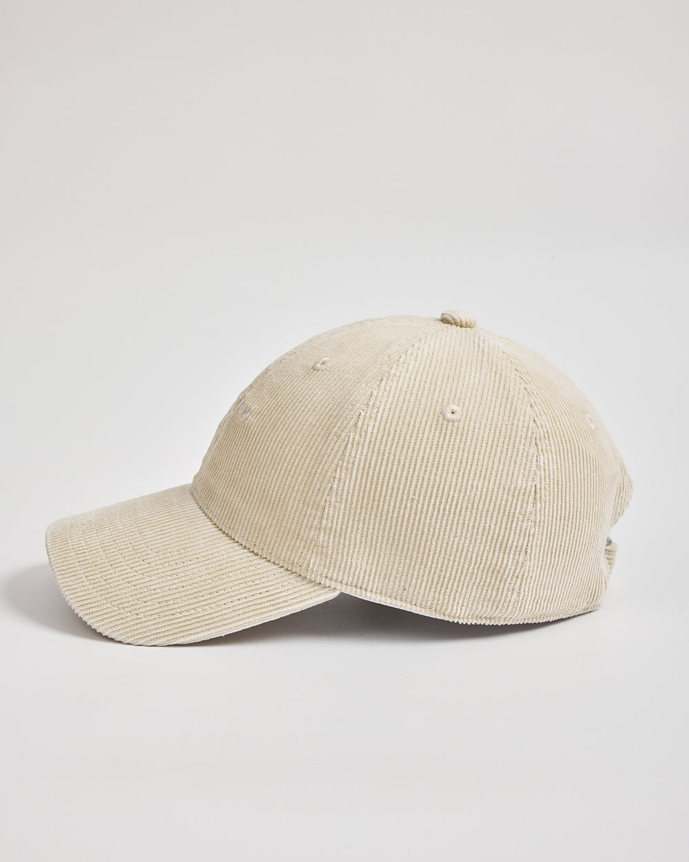 Cream corduroy cap on a light gray background