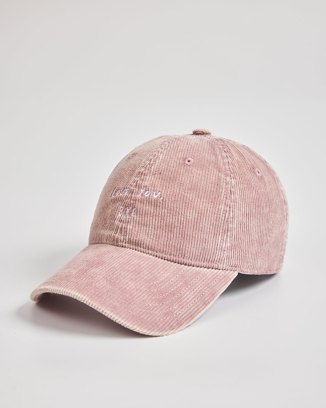 Pink corduroy cap on a light gray background