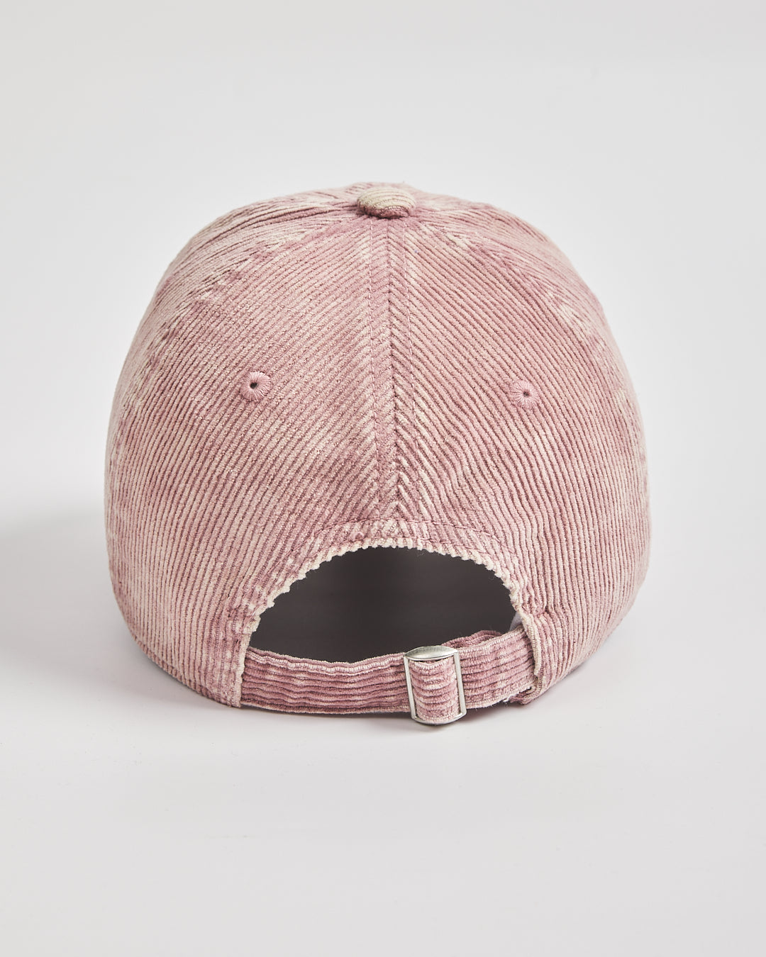 Pink corduroy cap on a light gray background