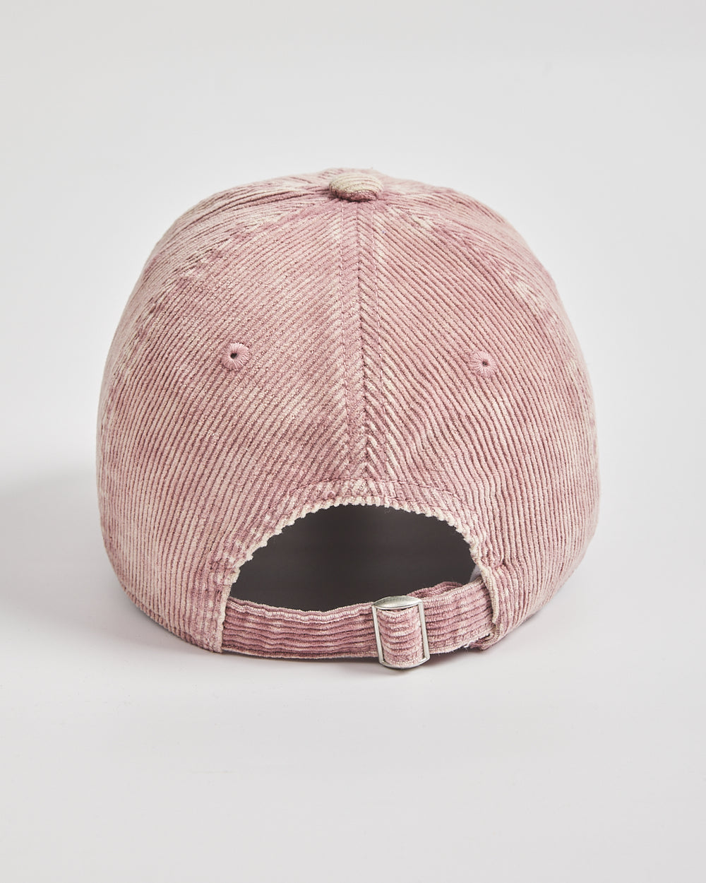 Pink corduroy cap on a light gray background
