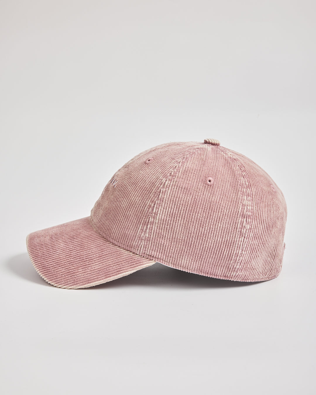 Pink corduroy baseball cap on a light gray background