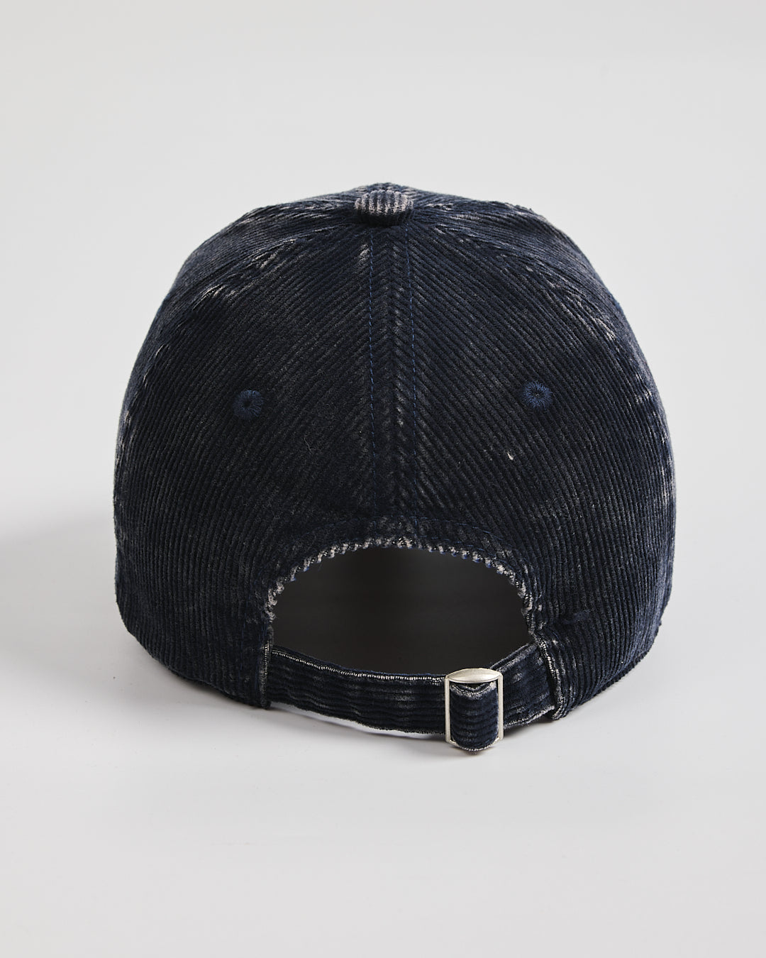 Navy blue corduroy cap on a light gray background