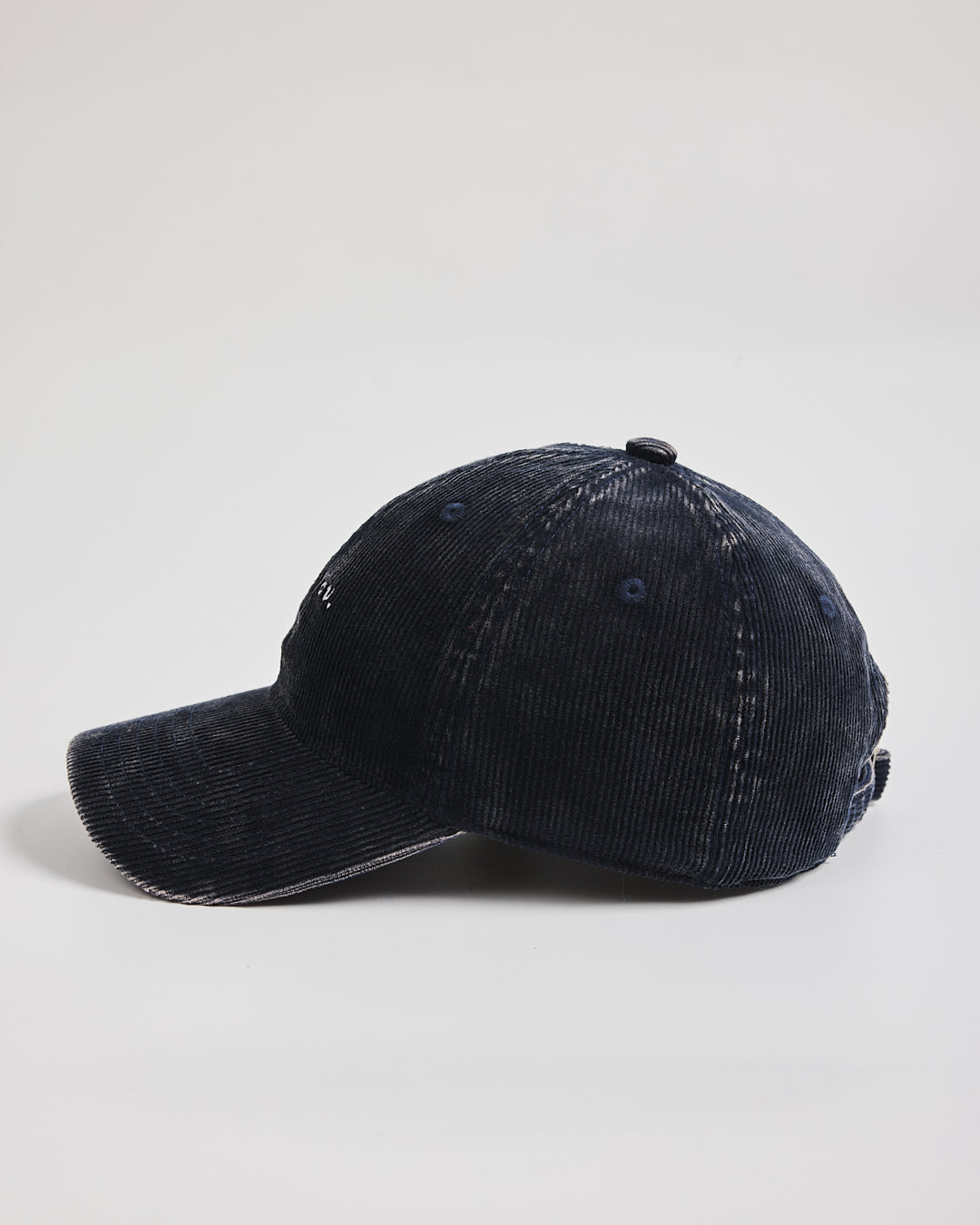 Navy blue corduroy baseball cap on a light gray background