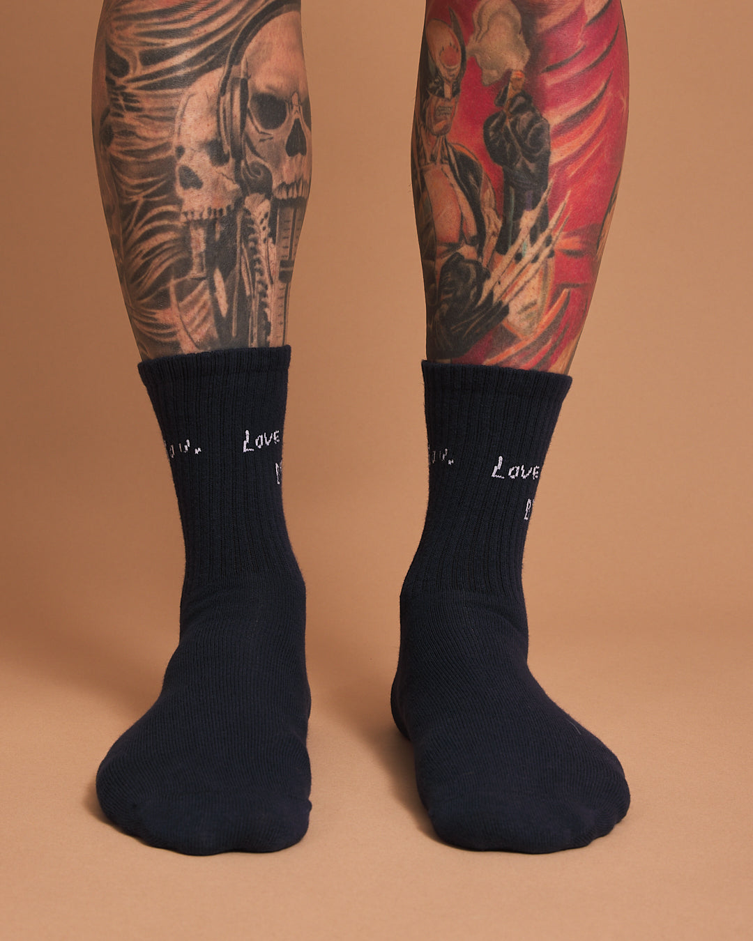 Front look of navy socks with 'love you, bye' text on a brown background