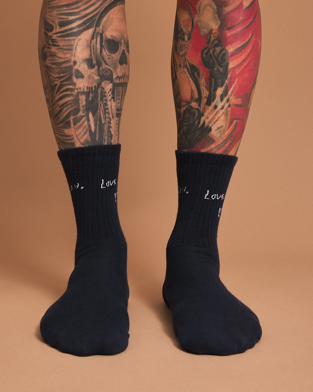 Front look of navy socks with 'love you, bye' text on a brown background