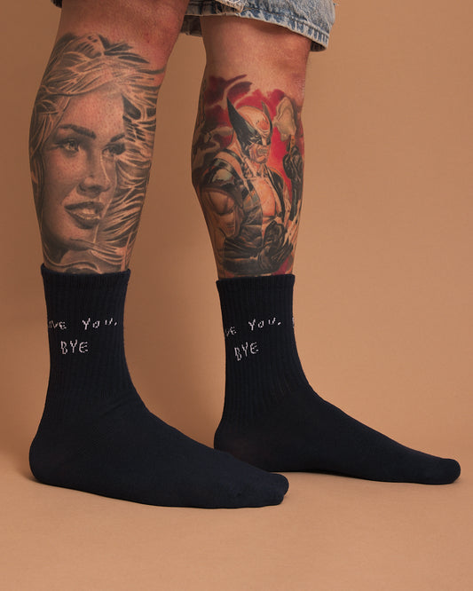 right side of Navy socks with 'love you, bye' text on a brown background