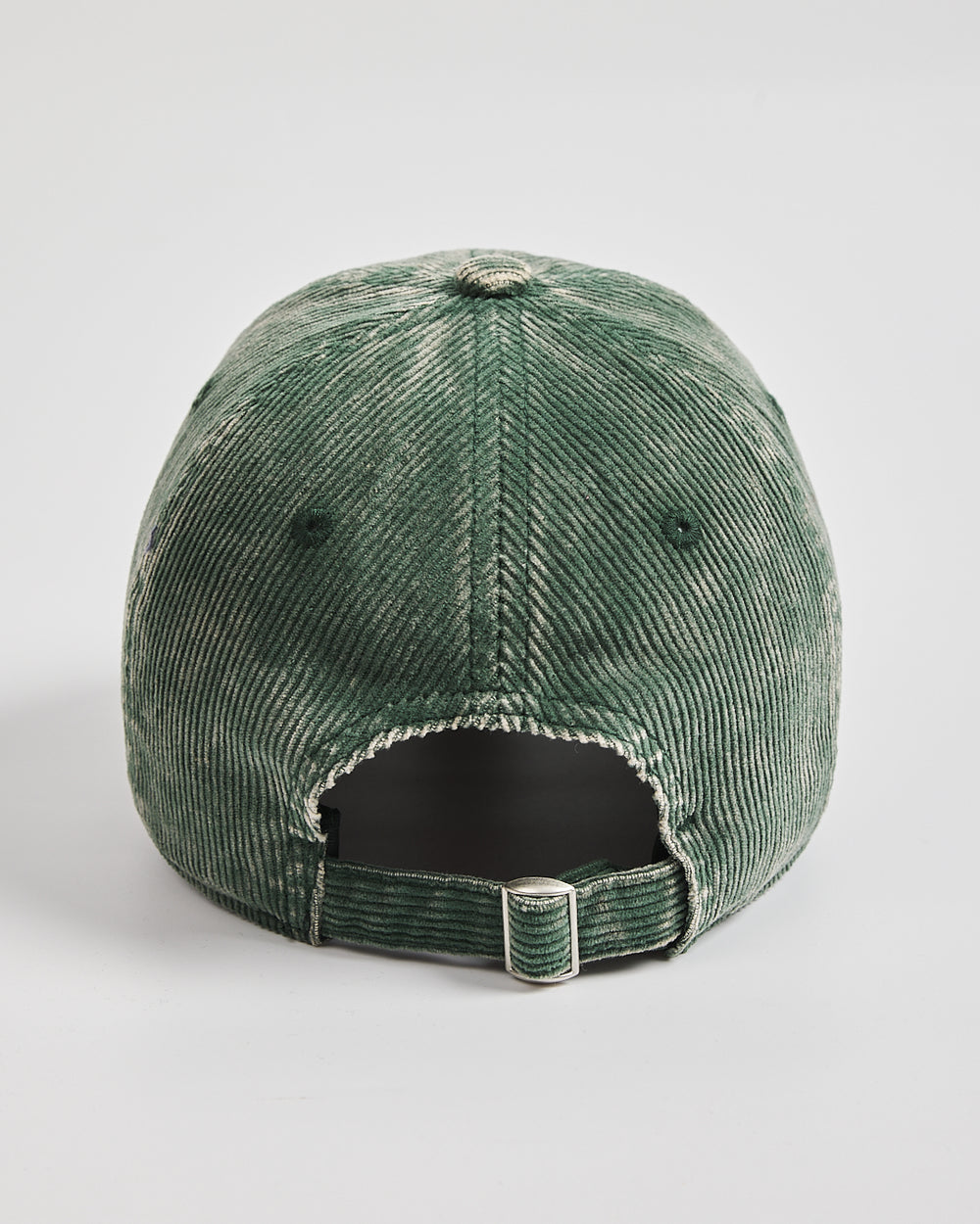 Green corduroy cap on a light gray background