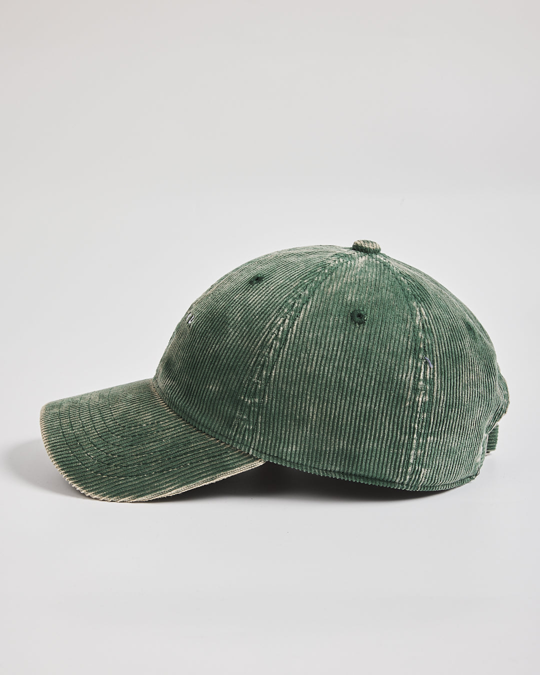 Green corduroy cap on a light gray background