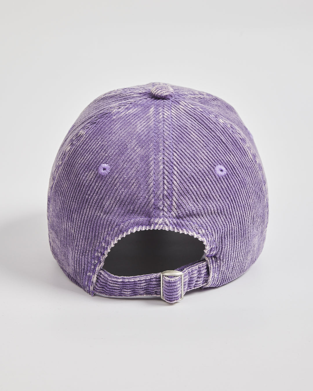 Purple corduroy cap on a light gray background