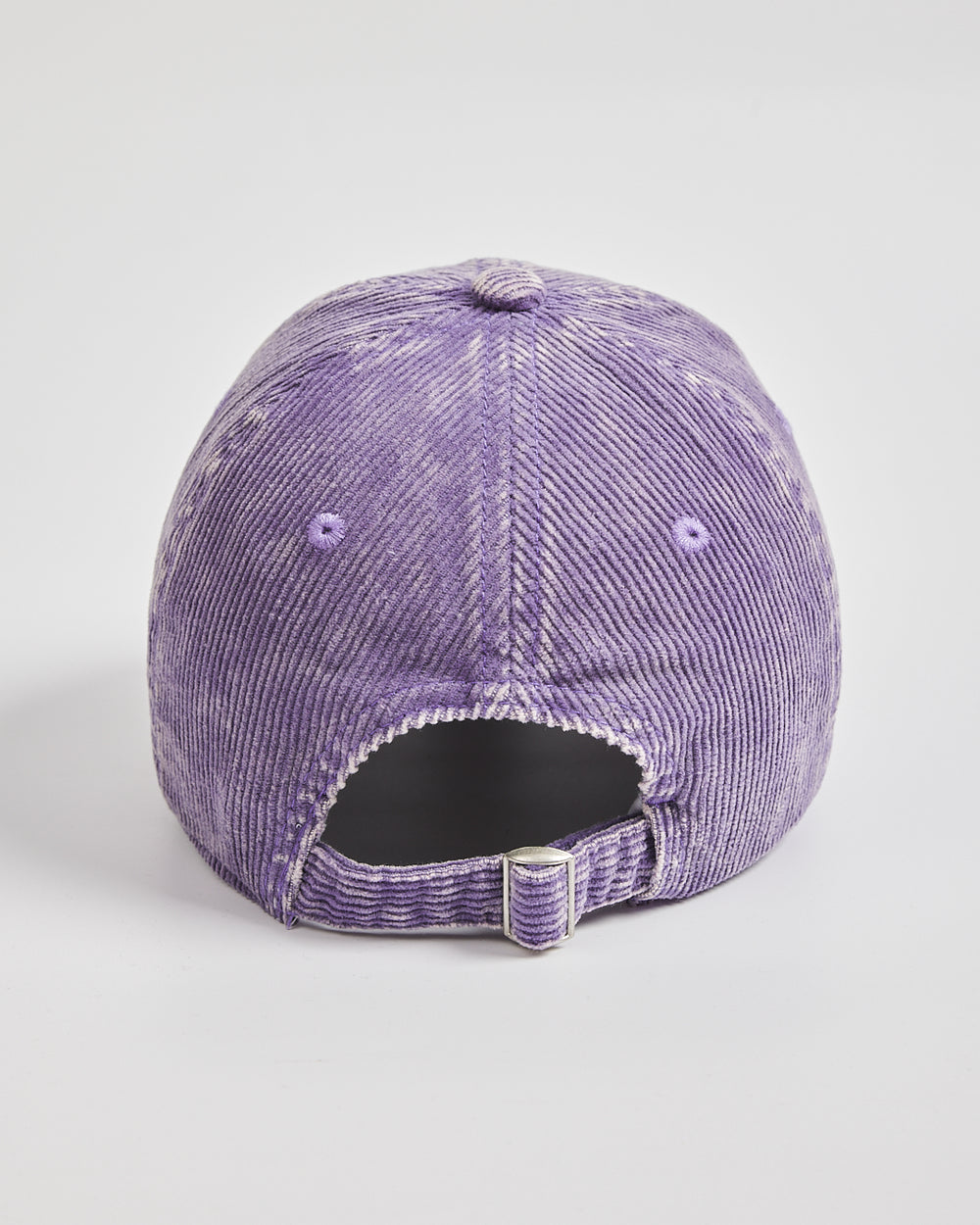 Purple corduroy cap on a light gray background