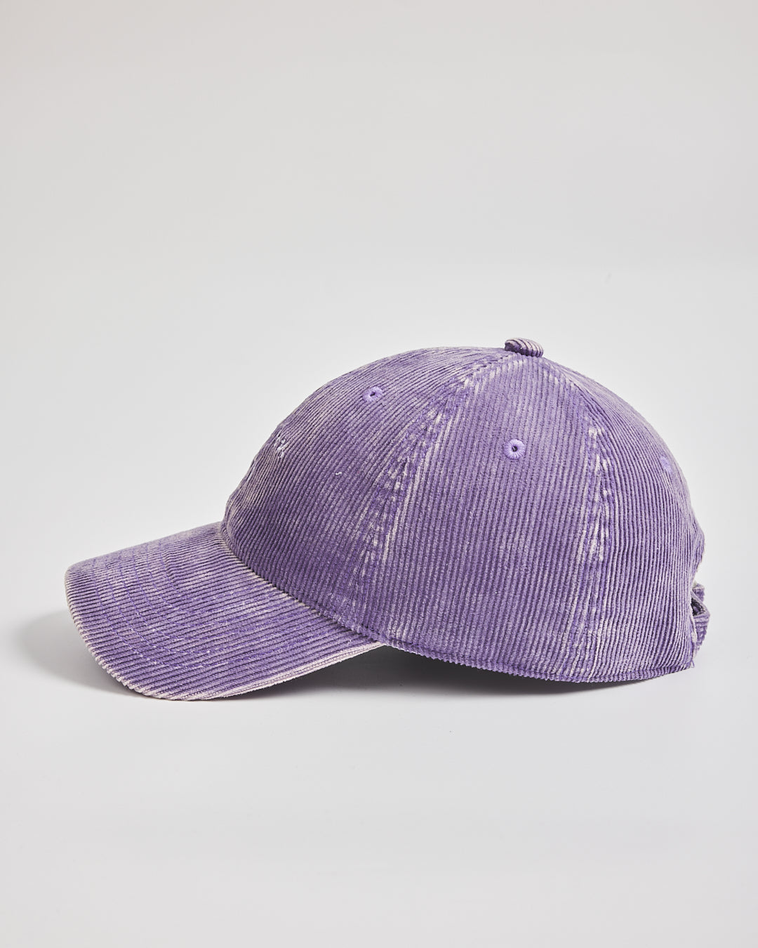 Purple corduroy cap on a light gray background