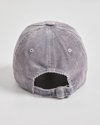 Back view of stone grey corduroy cap on a light gray background