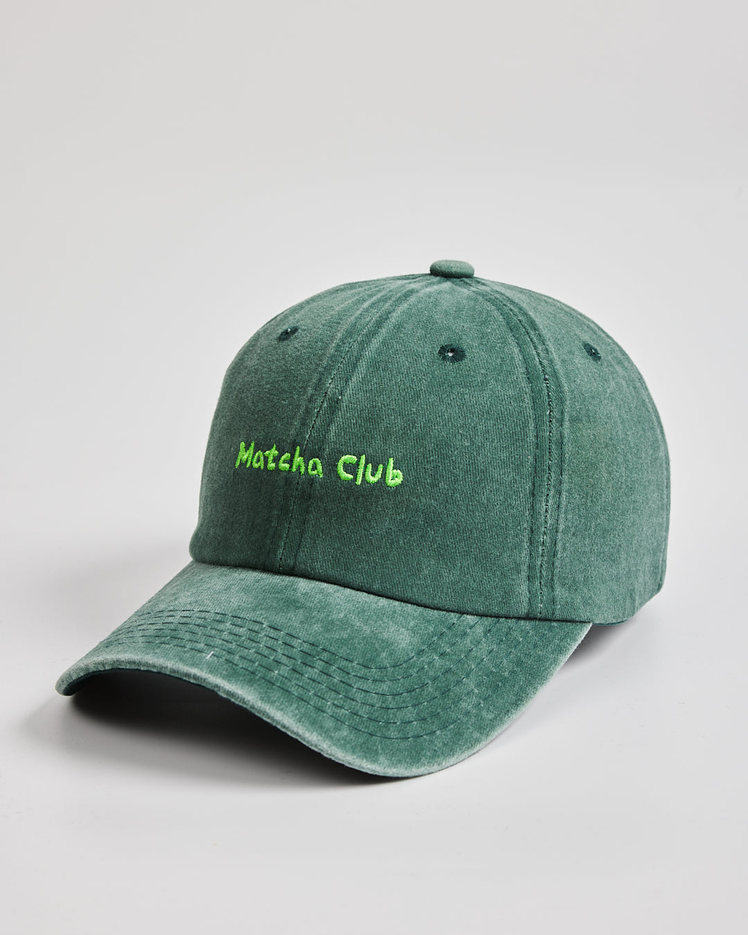 Side view of Matcha Club Dark Green Washed Cap
