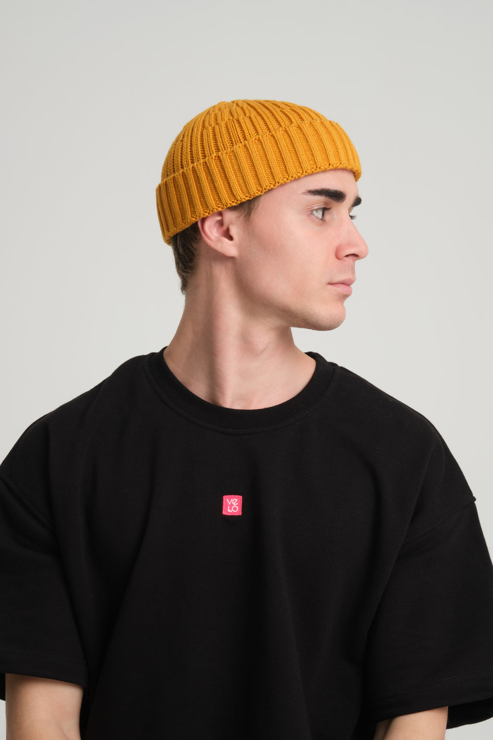 side view of a man wearing Mustard Fisherman Beanie