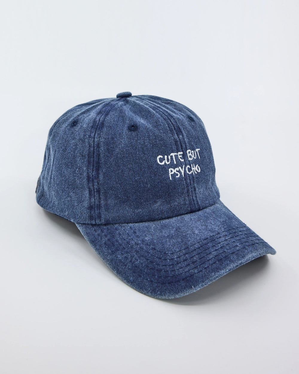 side view of Cute But Psycho Navy Blue Washed Cap