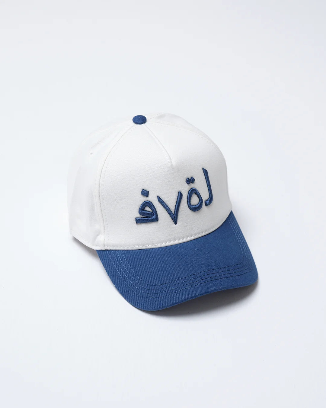 side of navy love written baseball cap on a white background