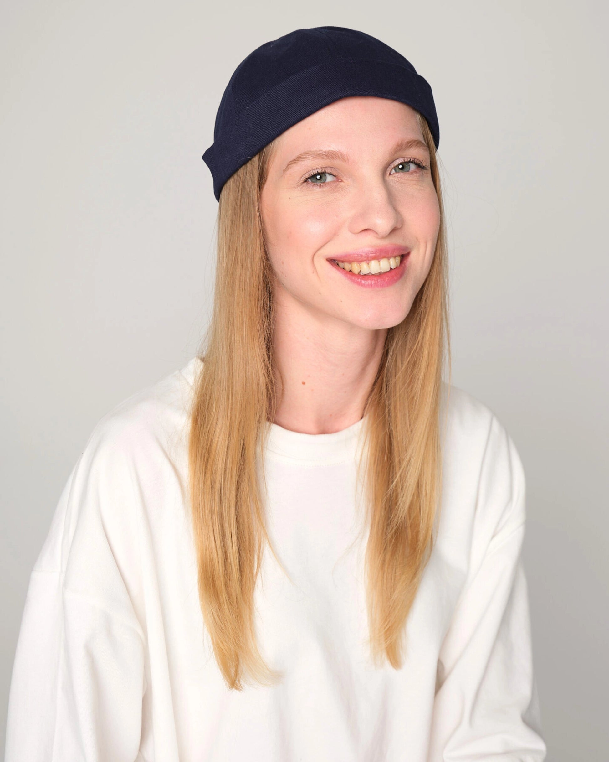 woman wearing navy docker cap