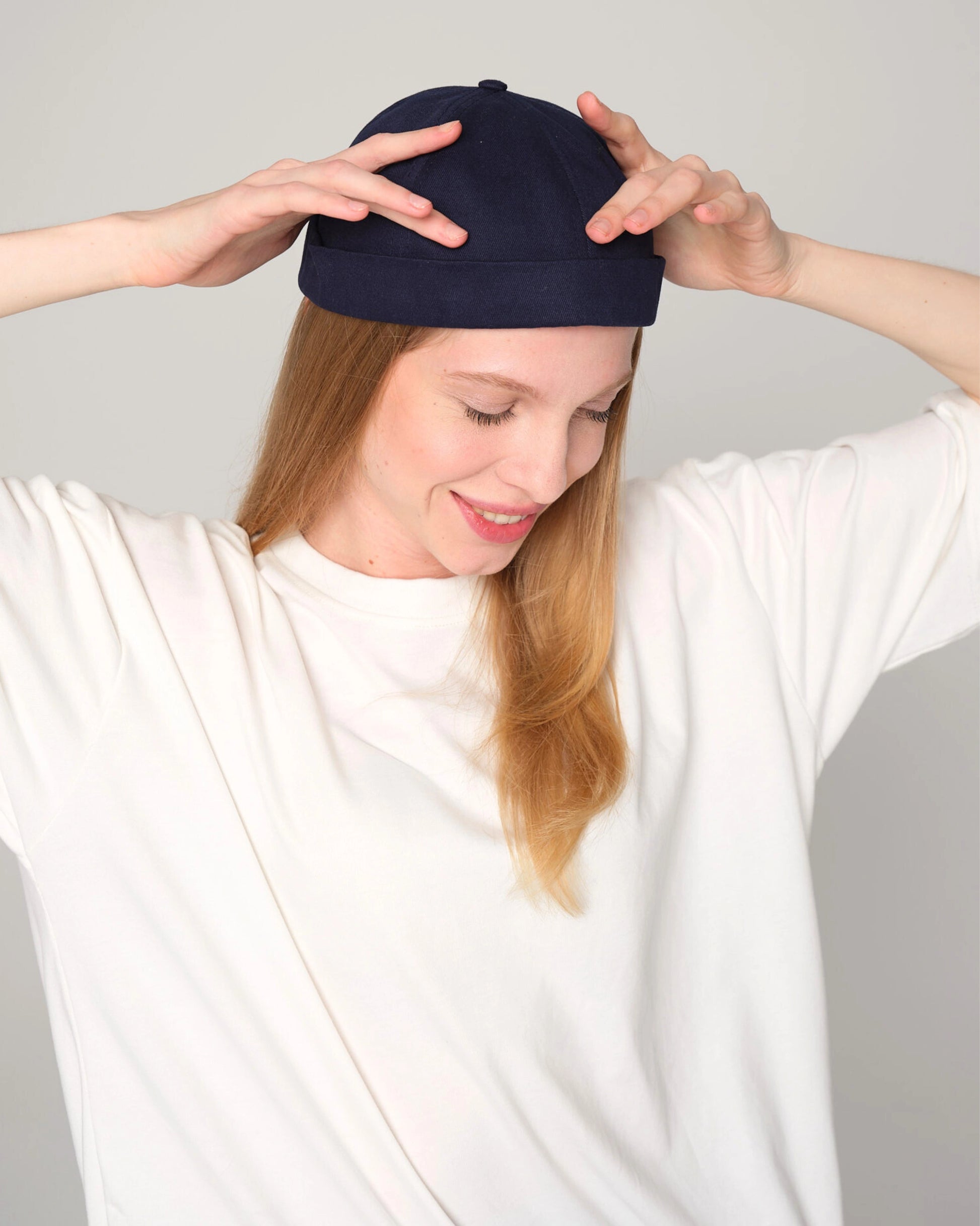 woman wearing navy docker hat