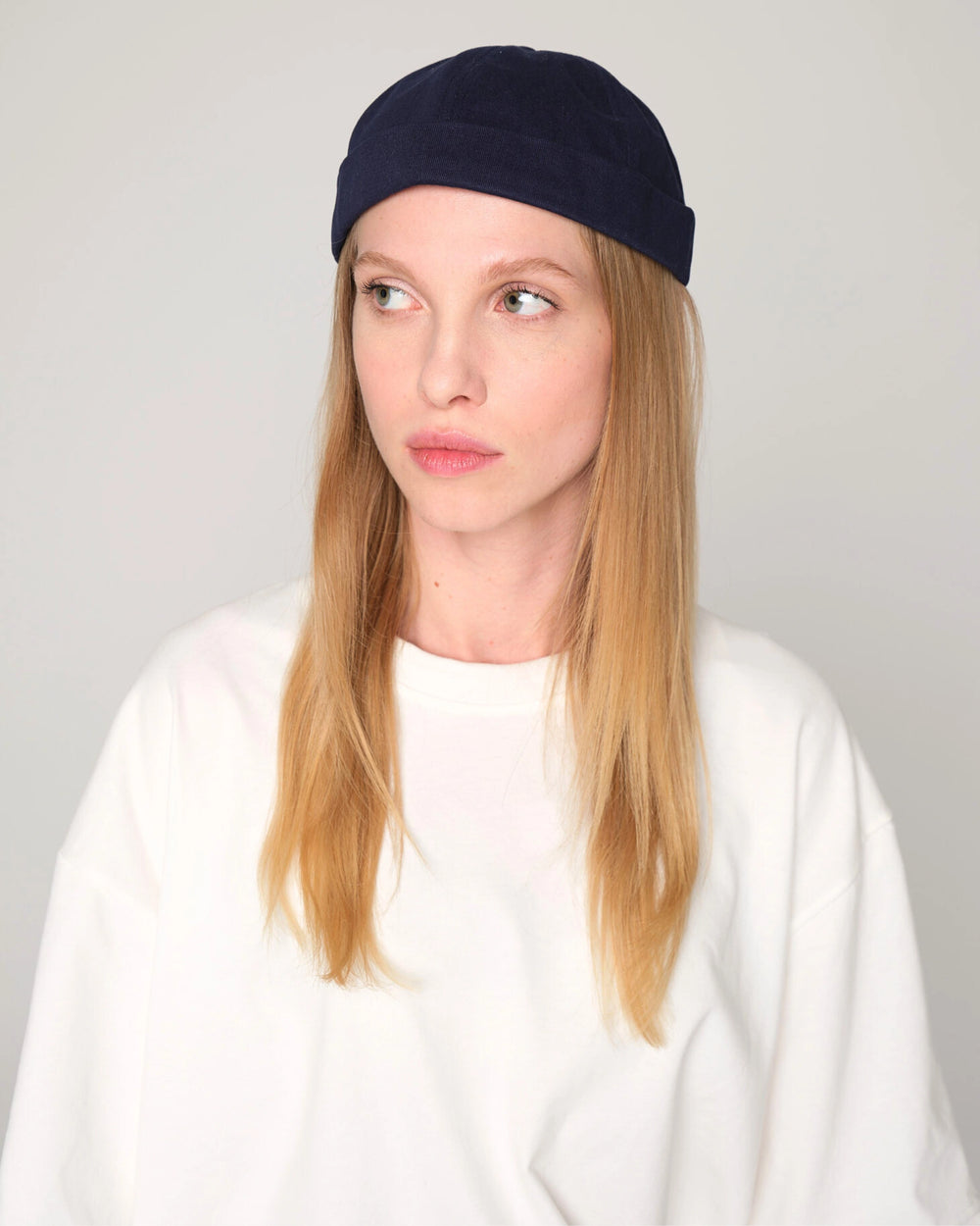 woman wearing navy blue docker hat