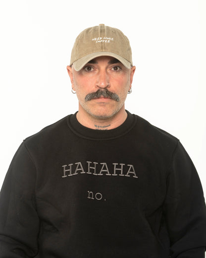 A man wearing the Need More Coffee Beige Washed Cap