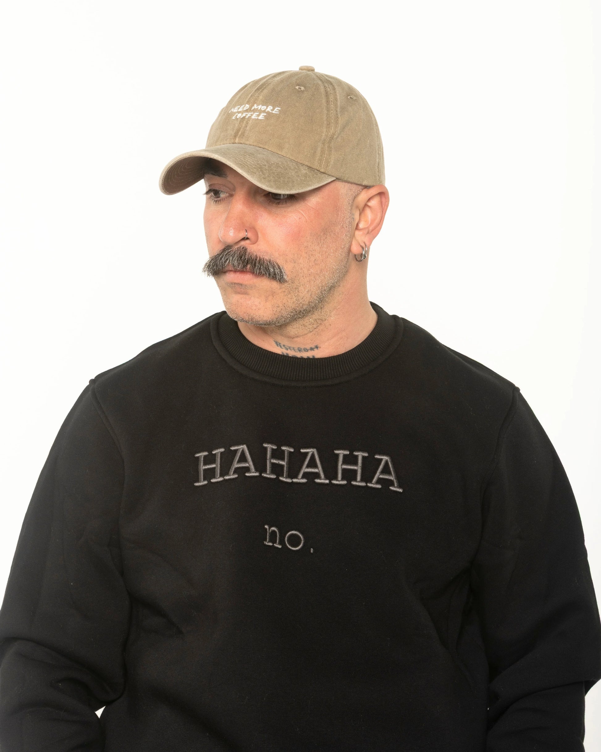 A man wearing the Need More Coffee Beige Washed Cap