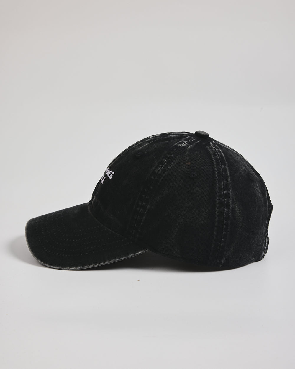 Need More Coffee Black Washed Cap on a light gray background