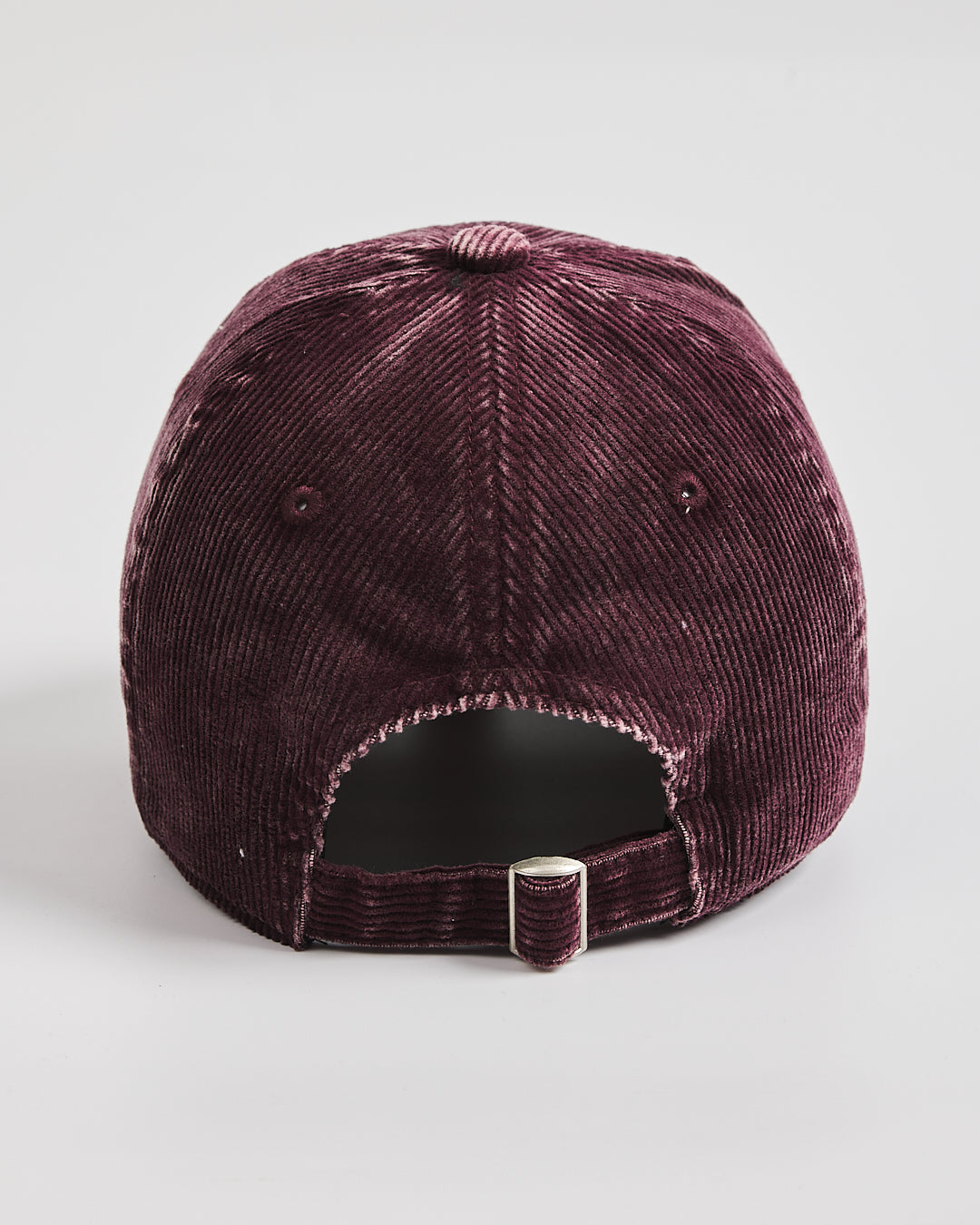 Purple velvet cap on a light gray background