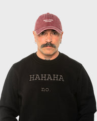 A man wearing the Need More Coffee Burgundy Washed Cap