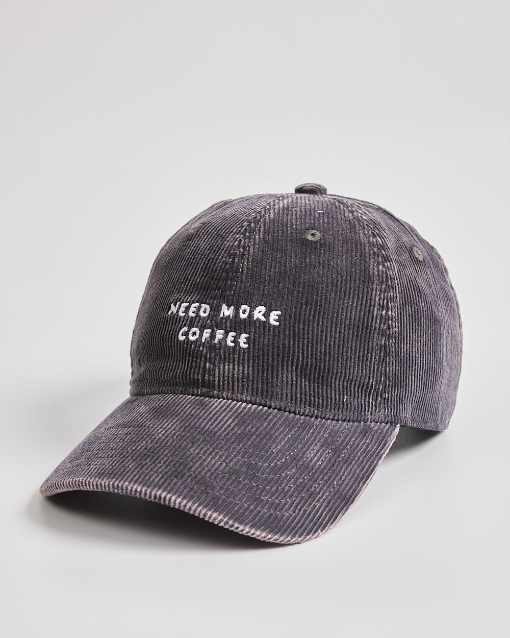 Gray cap with 'Need More Coffee' text on a light gray background