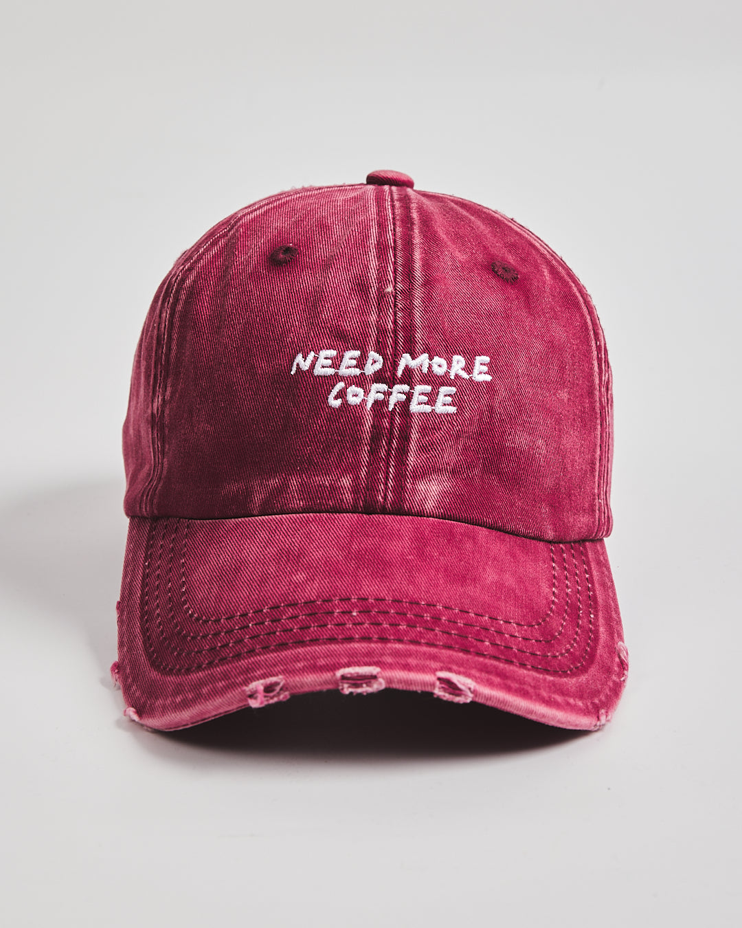 Front view of Need More Coffee Cherry Washed Cap
