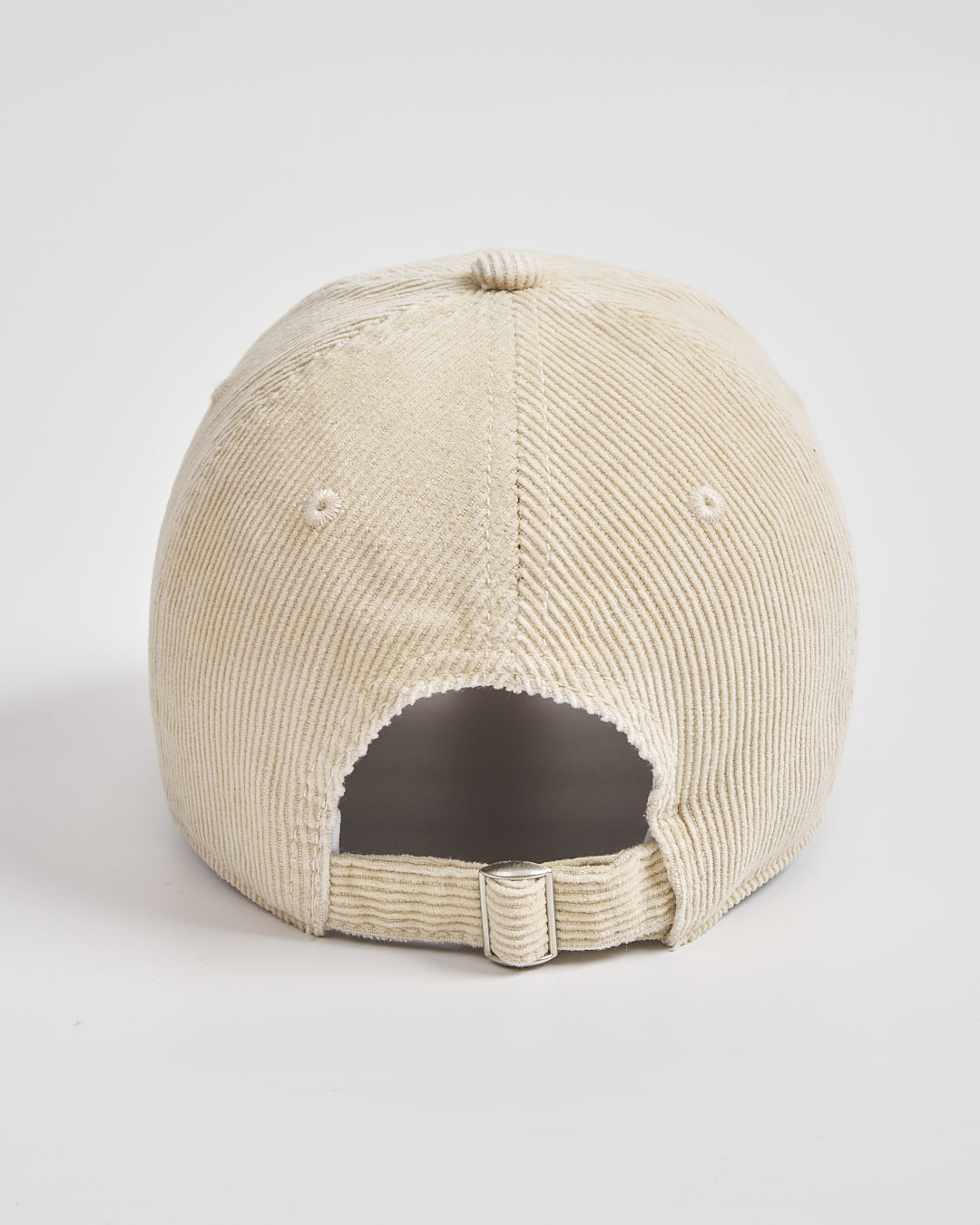 Cream corduroy cap on a light gray background